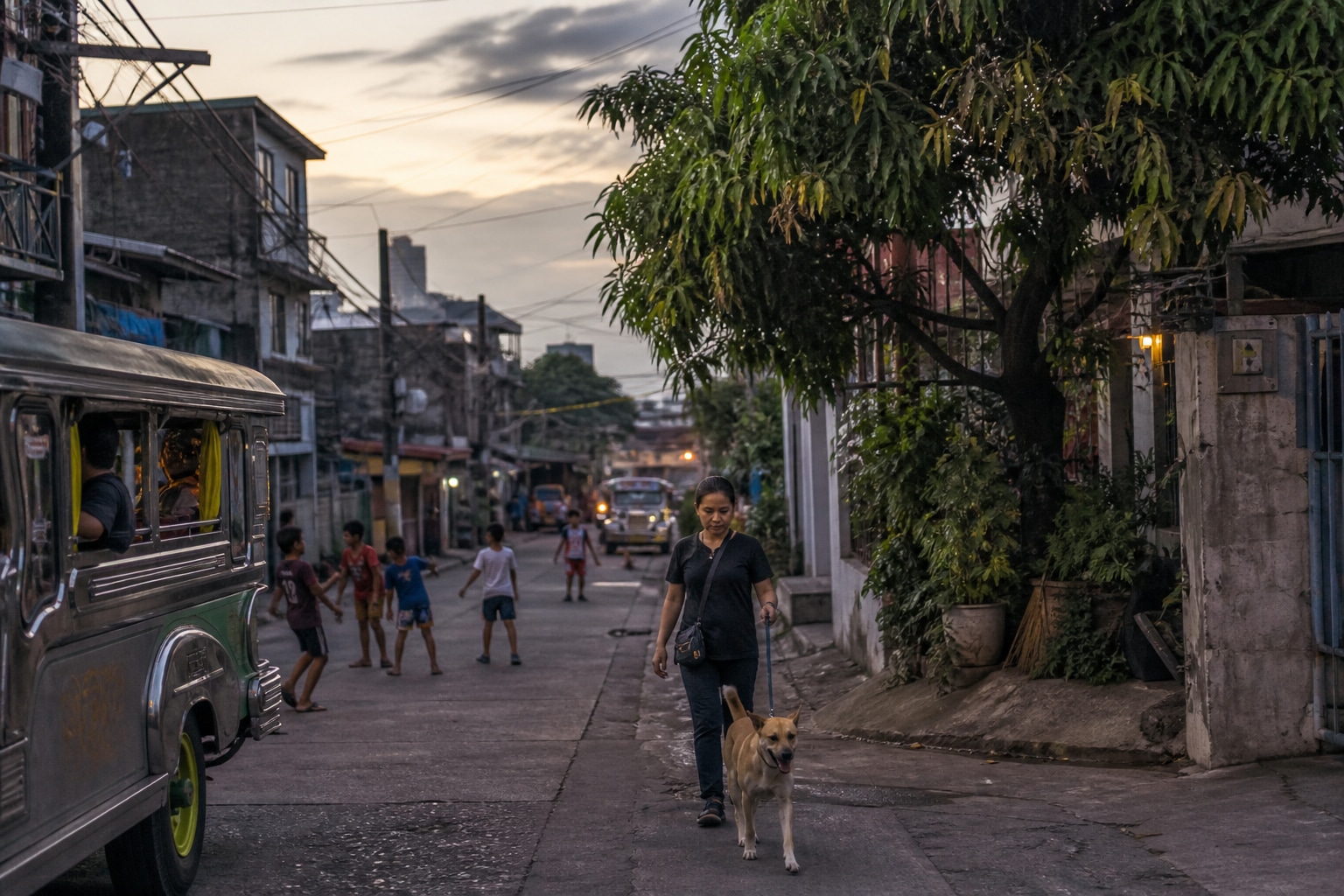 Quezon City residential street at dusk with a rescuer and aspin